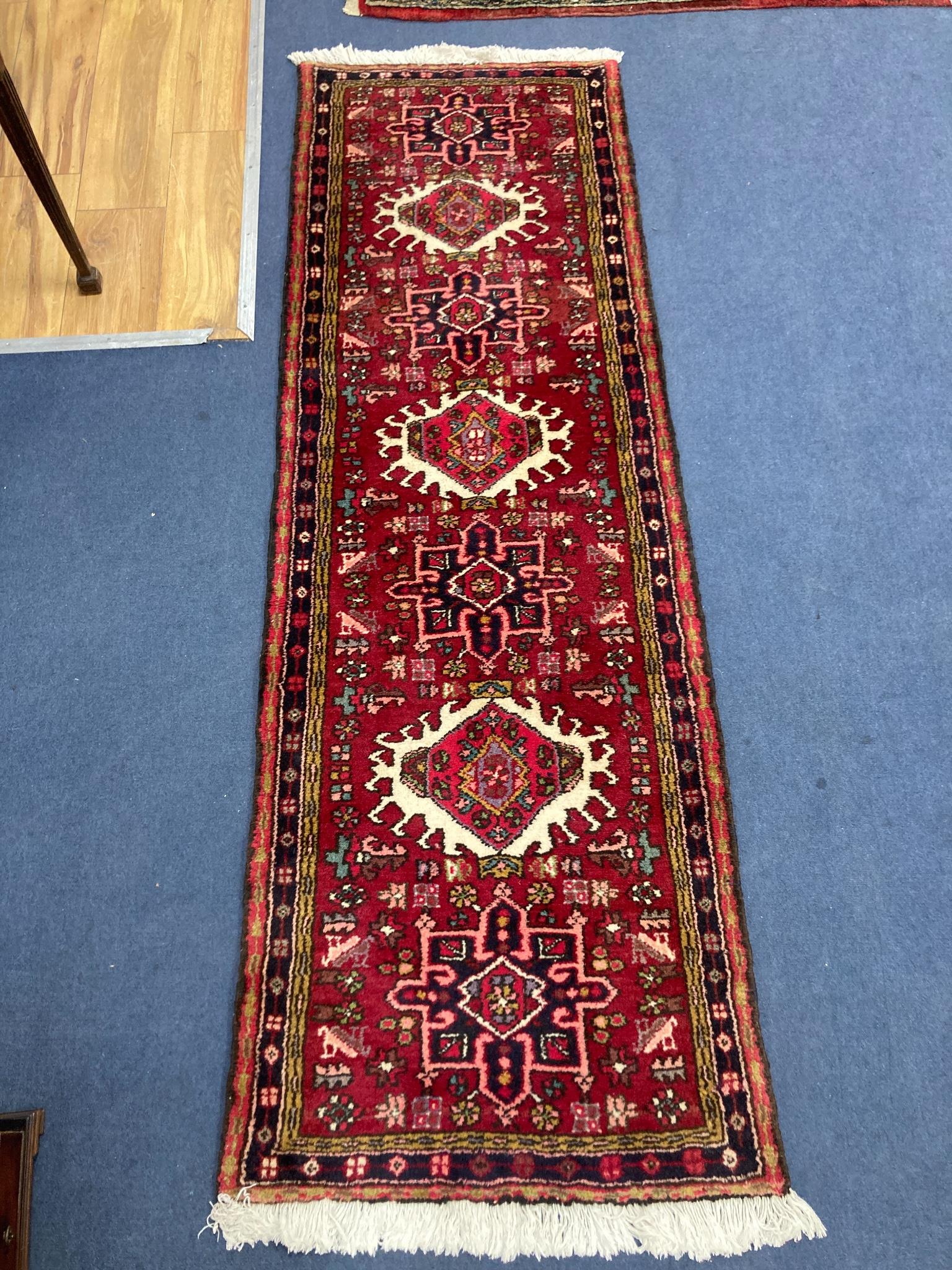 A red ground Persian rug, 210 x 135cm together with a smaller Caucasian style runner